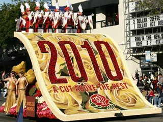 A big float in a parade that has the words, "2010 a cut above the rest" written on it.