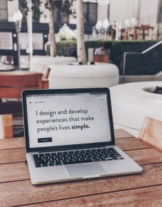 Laptop with screen saying, “I design and develop experiences that make people’s lives simple.” Image by Ben Kolde, via Unsplash.com.